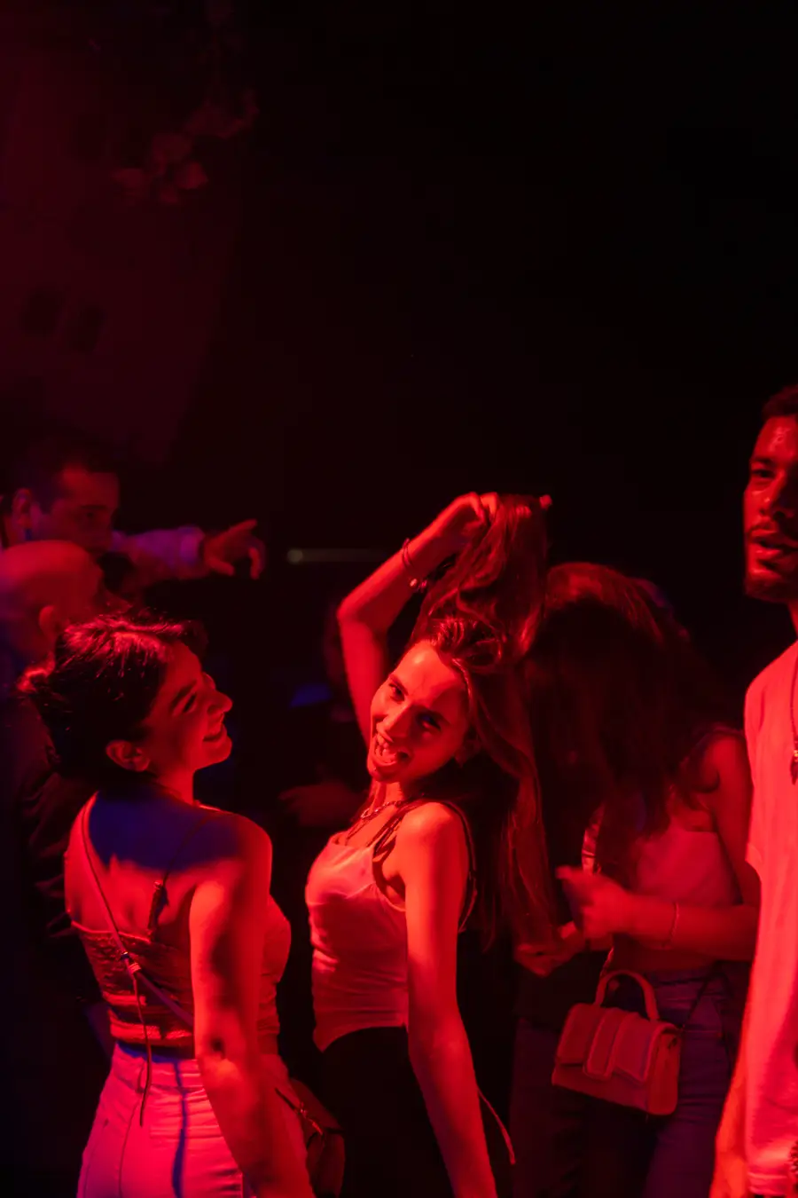 Girls dancing in red light at a Tbilisi nightclub